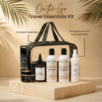 Travel Essentials Kit with hair care products on a wooden platform against a beige background with palm leaves.